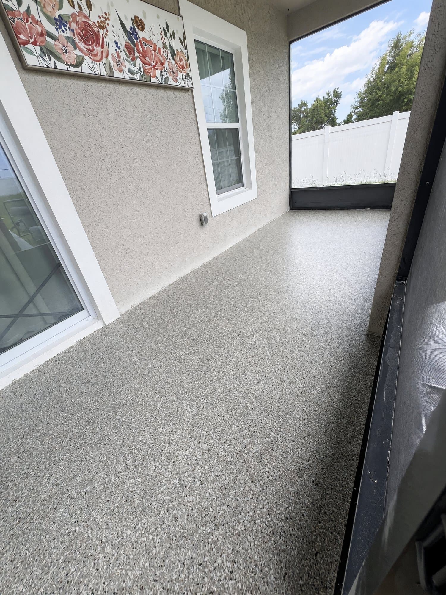 Gray-tan flake epoxy floor on a covered lanai